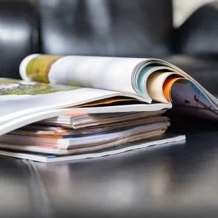 A stack of magazines on a desk